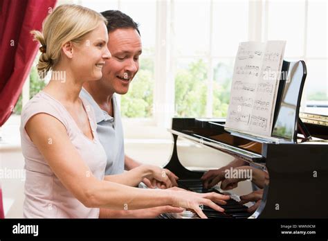 Couple Playing Piano And Smiling Stock Photo Alamy