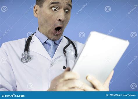 Portrait Of Shocked Male Doctor With Stethoscope Looking At Laptop Stock Photo Image Of Blue