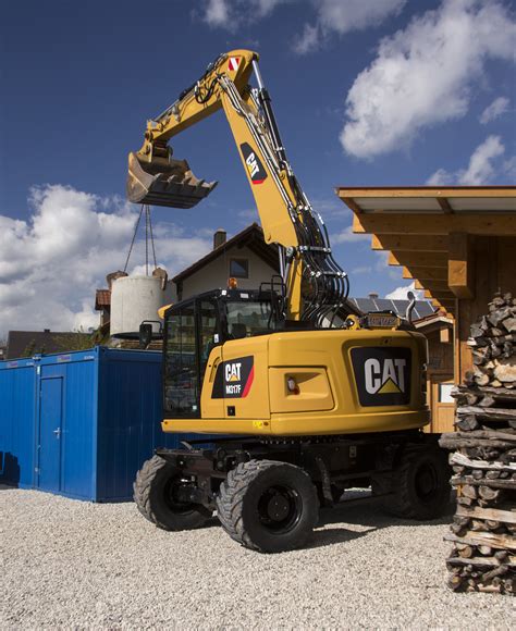 Cat M317f Wheeled Excavator Lifting On Site Magazine