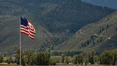 American Flag Flying In The Rocky Mountians Stock Photo Image Of