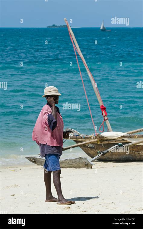 Fisherman Making A Phone Call With His Handy On The Beach In Stone Town