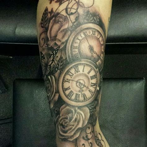 A Womans Leg With Roses And Clocks On It