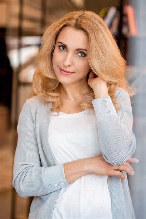 Blonde Mature Woman Smiling And Using Laptop During Yoga Practice Stock Photo Image Of