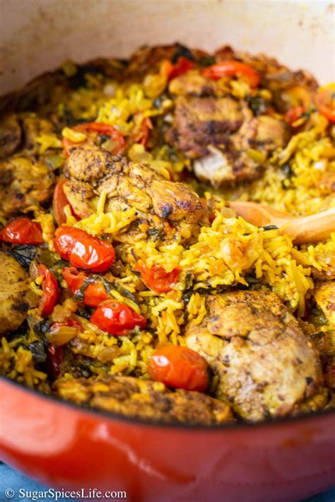 Layers of vegetables and meat are placed inside a dutch oven, followed by the red rice. Middle Eastern Chicken and Rice Recipe - Sugar Spices Life