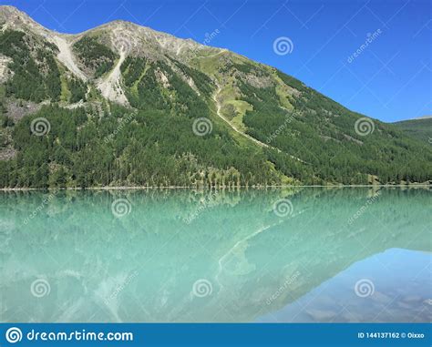 Beautiful Turquoise Kucherla Lake Reflection Of Mountains In The Water
