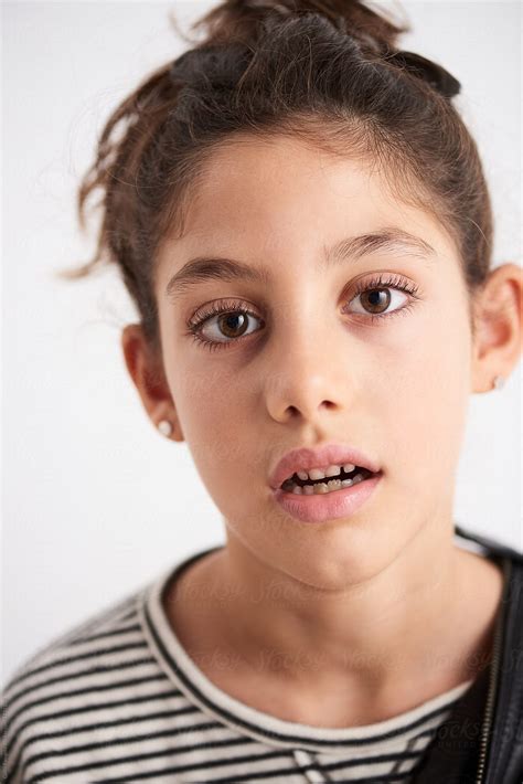 Headshot Of Teen Girl With Open Mouth Looking At Camera By Stocksy Contributor Guille