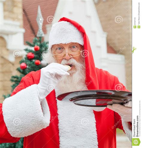 Santa Claus Eating Cookie Against House Stock Photo Image Of Saint