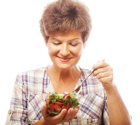 premium photo mature smiling woman eating salad