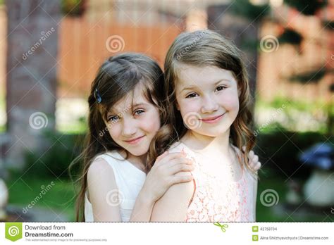 Two Best Friends Posing Together In Garden Stock Photo