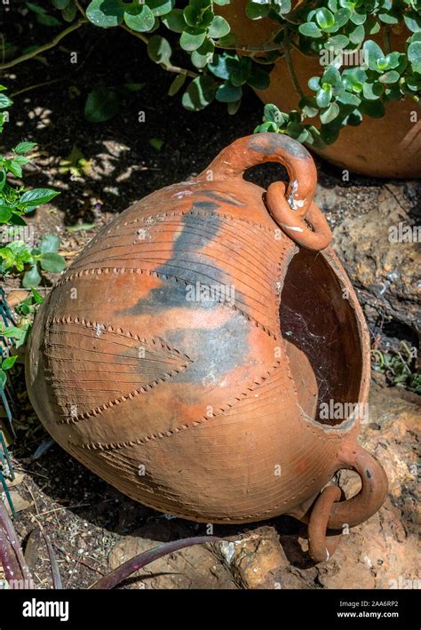 Handcrafted Traditional African Clay Pot Isolated In A Garden Image In