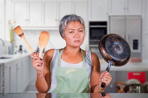 Attractive Upset And Stressed Woman 40s To 50s Tired And Unhappy At Home Kitchen Doing Housework