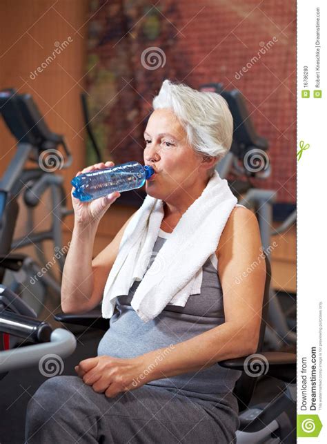 Senior Woman Drinking Water In Gym Stock Photo Image