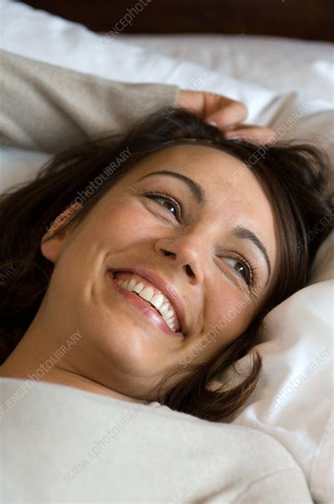 Smiling Woman Laying In Bed Stock Image F Science Photo Library