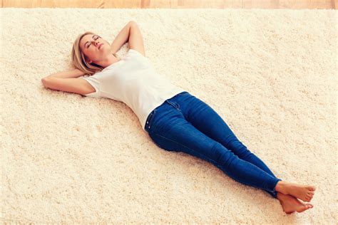 Young Woman Lying Down On A Carpet Royalty Free Stock Image Storyblocks