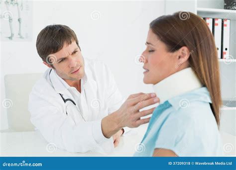Doctor Examining A Patients Neck In Medical Office Stock Photo Image