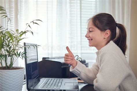 Smiling Young Girl Using Computer At Home Office Workplace Exploring