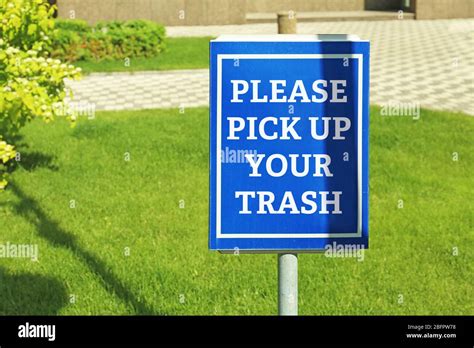 Signboard With Text Please Pick Up Your Trash At Park Stock Photo Alamy