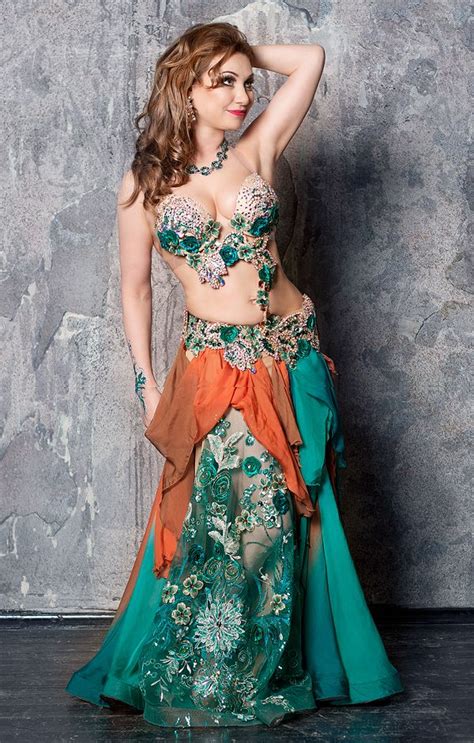 A Woman In A Green And Orange Belly Dance Outfit