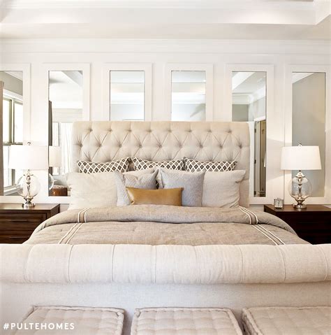 Go big with a mirror-lined wall behind your headboard ...