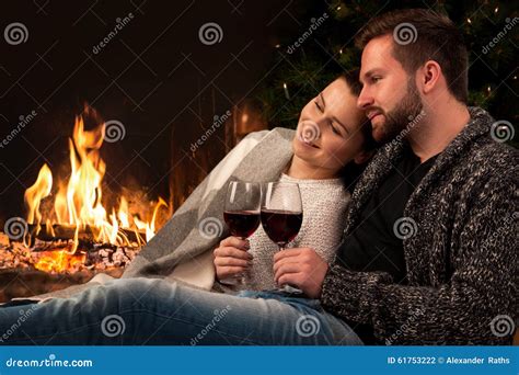 Couple With Glass Of Wine At Fireplace Stock Photo Image