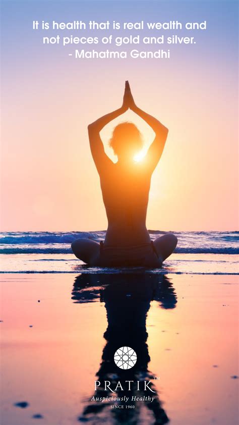 A Woman Sitting On The Beach Doing Yoga With Her Hands Up In The Air