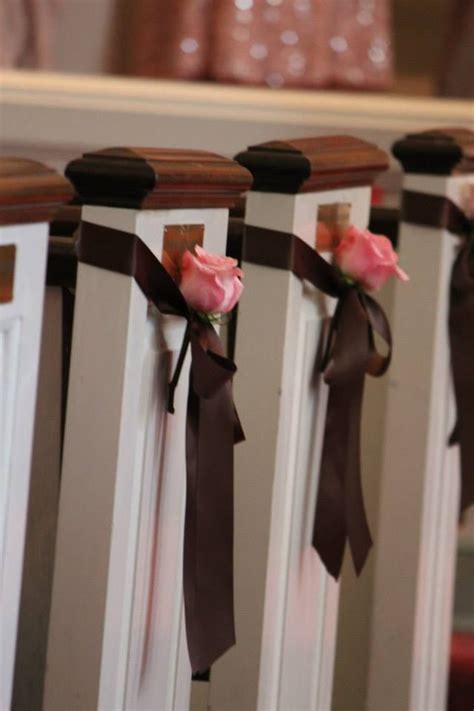 Pink Roses Tucked Into A Brown Satin Bow Hanging From The Pews Simple