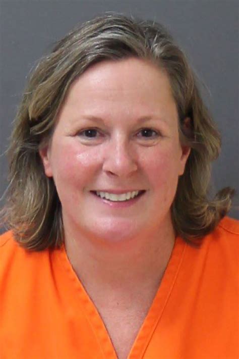 Convicted killer Kim Potter smiles in mugshot