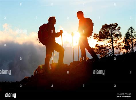 Hiking Couple Looking Enjoying Sunset View On Hike During Trek In