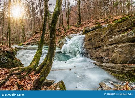 Frozen Waterfall Abow The Huge Boulder In Empty Forest Stock Image