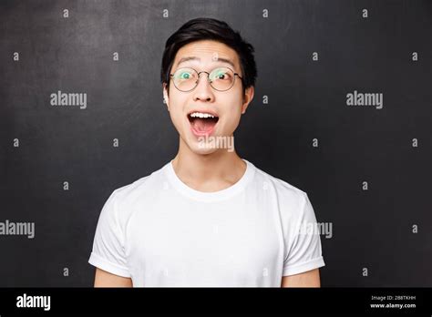 Close Up Portrait Of Amused And Wondered Enthusiastic Asian Man In White T Shirt And Glasses