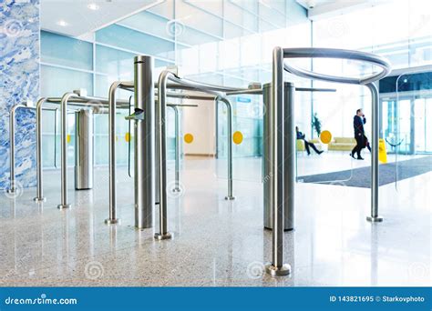 Stylish Turnstiles Made Of Glass And Metal In The Lobby Of An