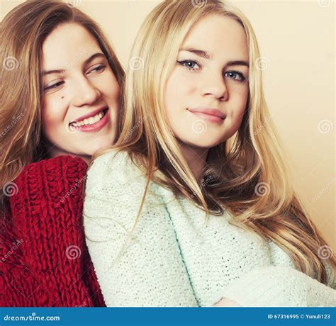 Two Young Girlfriends In Winter Sweaters Indoors Having Fun Lifestyle Stock Image Image Of