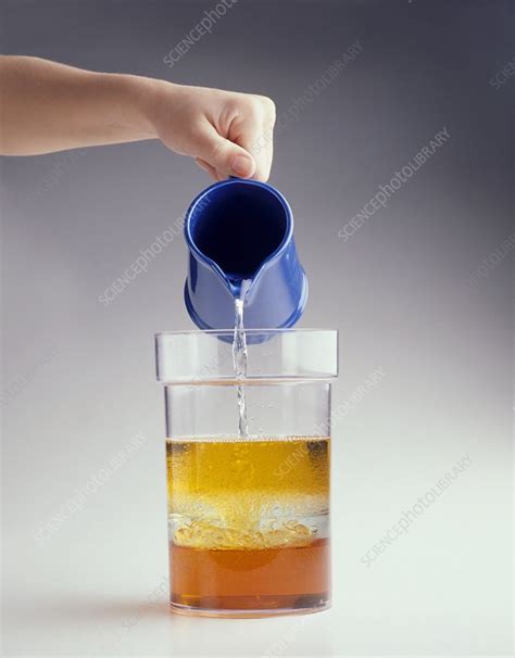 Hand Pouring Jug Of Water Into Container Stock Image C0198774
