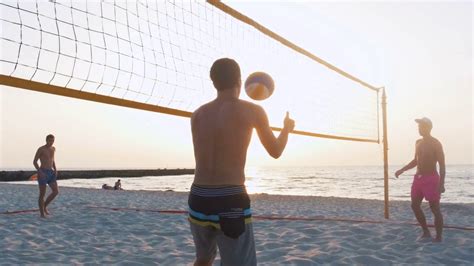group of people playing beach volleyball during sunrise or sunset stock video footage 00 17 sbv