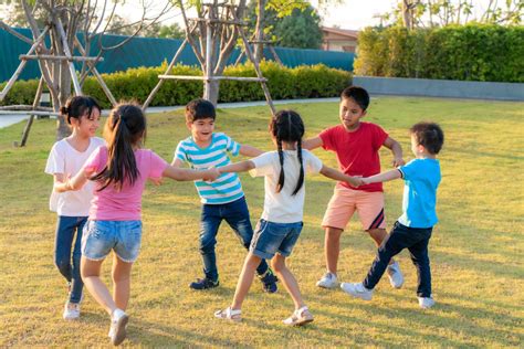Large Group Of Happy Asian Smiling Kindergarten Kids Friends Holding