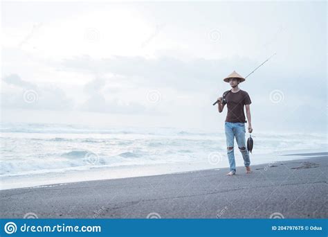 Portrait Of A Young Fisherman Walking Alone Stock Image Image Of
