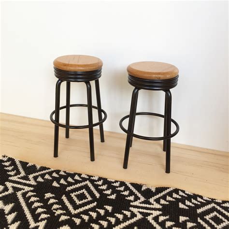 A very chunky and solid wooden stool. Black metal bar stools with a wooden seat. Great for ...
