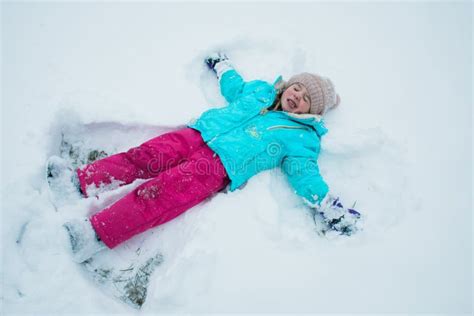 A Young Girl Making Snow Angels Stock Photo Image Of Outside