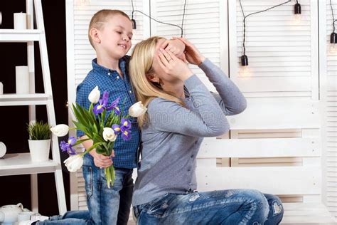 Son Congratulates His Beloved Mother And Gives Her A Bouquet Of Tulips