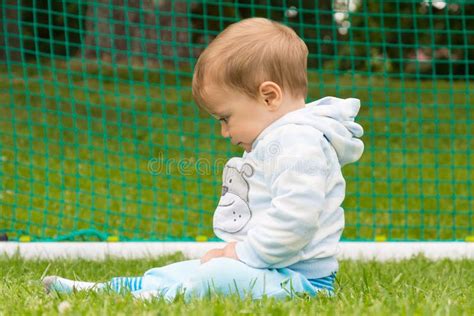 Little Boy Playing On The Football Field With Gates Stock Photo Image