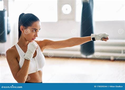 Female Boxer Practicing Her Punches At A Boxing Studio Stock Photo