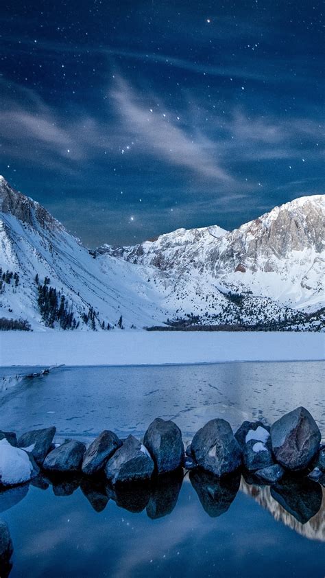 Download Wallpaper 1080x1920 Snowy Mountains Starry Night Lake Rocks