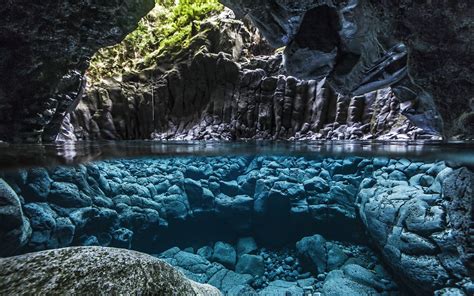 An Underwater View Of Some Rocks And Water