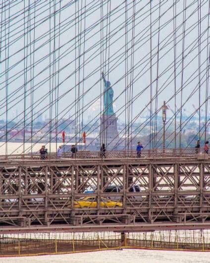 Statue Of Liberty Viewed Through The Brooklyn Bridge