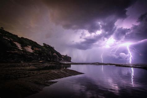 Thunderstorm Lightning Near Body Of Water And Rock Formation Nature