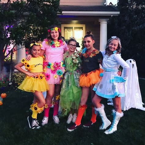 A Group Of Girls Dressed Up In Costumes Posing For A Photo Outside