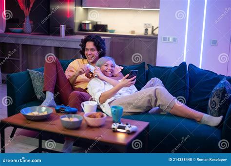 Happy Boyfriend And Girlfriend Playing Video Games And Holding