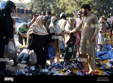 Islamabad, Pakistan. 18th Dec, 2022. People buy shoes at a flea market