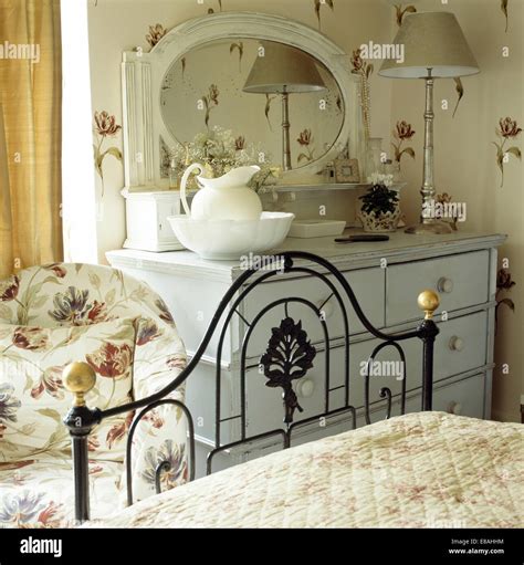 Ornate Black Wrought Iron Bed In Cottage Bedroom With Tulip Patterned