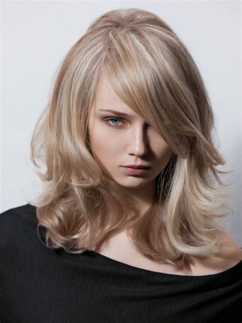 This combination of strawberry blonde and lighter colors creates a super hot statement of spice! Long hairstyle with layers and a deep plunging fringe